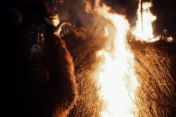 traditional buso mask of the busojaras event next to a bonfire