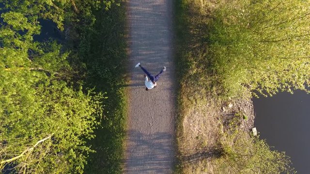 Young breakdancer performing thomas flare dance move. Hip hop drone view