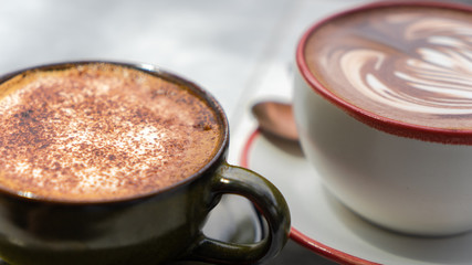 Cappuccino and Mocha on a stone table in a coffee shop in Thailand