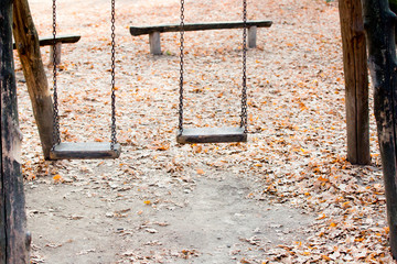 swing in the park and leaves in the background