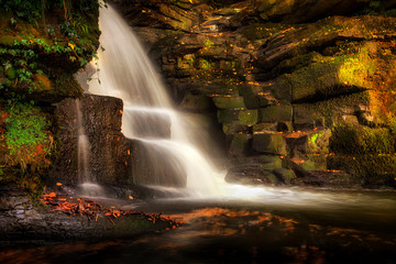 Fototapeta na wymiar An almost unknown man made industrial waterfalls near Neath Abbey on the river Clydach, Skewen, South Wales, UK