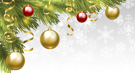 Christmas tree branches with baubles and golden serpentine streamers