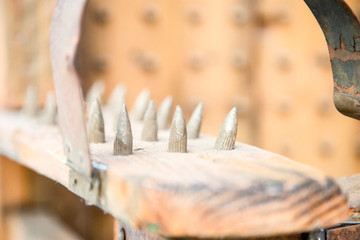 old wooden chair with spikes for torture