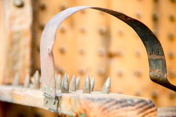 old wooden chair with spikes for torture