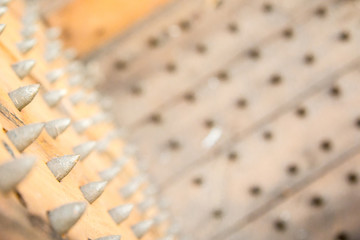 old wooden chair with spikes for torture