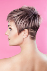 Portrait of a beautiful blonde woman with beautiful make-up and short haircut after dyeing hair in...