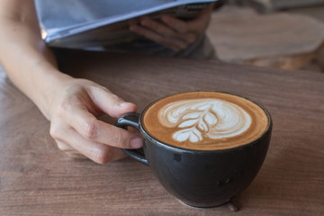 Close up of Cup of hot latte art coffee on wooden table