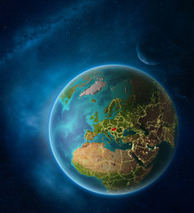 Planet Earth with highlighted Hungary in space with Moon and Milky Way. Visible city lights and country borders.