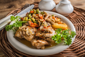 Fillet of chicken legs with stewed vegetables.