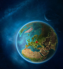Planet Earth with highlighted Belarus in space with Moon and Milky Way. Visible city lights and country borders.