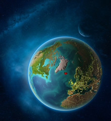 Planet Earth with highlighted Iceland in space with Moon and Milky Way. Visible city lights and country borders.