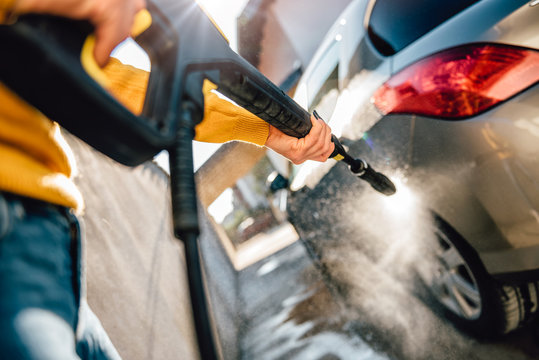 Woman Washing Her Car With Pressure Washer