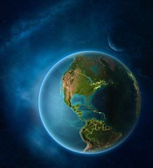 Planet Earth with highlighted Bahamas in space with Moon and Milky Way. Visible city lights and country borders.
