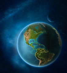 Planet Earth with highlighted Haiti in space with Moon and Milky Way. Visible city lights and country borders.