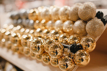 Colored gold and wite balls toys for the Christmas tree in store