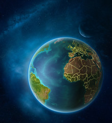Obraz na płótnie Canvas Planet Earth with highlighted Gambia in space with Moon and Milky Way. Visible city lights and country borders.