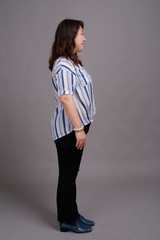 Full length portrait of Japanese businesswoman against gray background