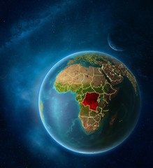 Planet Earth with highlighted Dem Rep of Congo in space with Moon and Milky Way. Visible city lights and country borders.