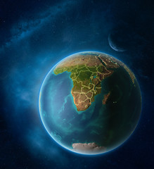 Planet Earth with highlighted eSwatini in space with Moon and Milky Way. Visible city lights and country borders.