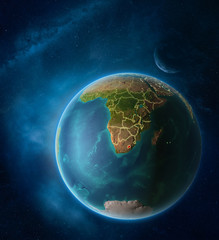 Planet Earth with highlighted Lesotho in space with Moon and Milky Way. Visible city lights and country borders.