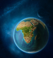 Fototapeta na wymiar Planet Earth with highlighted Malawi in space with Moon and Milky Way. Visible city lights and country borders.