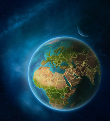 Planet Earth with highlighted Israel in space with Moon and Milky Way. Visible city lights and country borders.