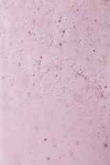 Macro photo of milky berry smoothie with bubbles. Food background