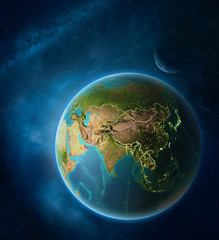 Planet Earth with highlighted Bhutan in space with Moon and Milky Way. Visible city lights and country borders.