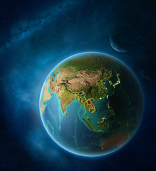 Planet Earth with highlighted Laos in space with Moon and Milky Way. Visible city lights and country borders.