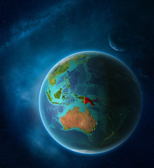 Planet Earth with highlighted Papua New Guinea in space with Moon and Milky Way. Visible city lights and country borders.