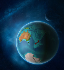 Planet Earth with highlighted New Zealand in space with Moon and Milky Way. Visible city lights and country borders.