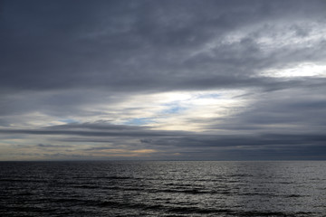 Dark cloud over sea.