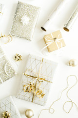 Fototapeta na wymiar Christmas, New Year holiday composition with golden gift boxes, decorations on white background. Flat lay, top view of gifts packaging.