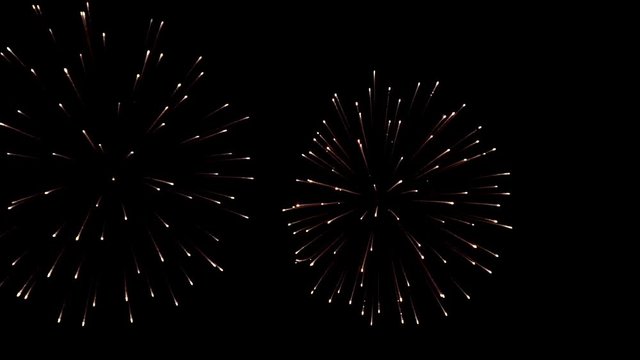 Bright colorful fireworks turn to multicolor bokeh lights at holiday dark summer night.