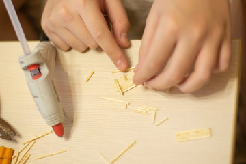 hands of the boy close-up making crafts