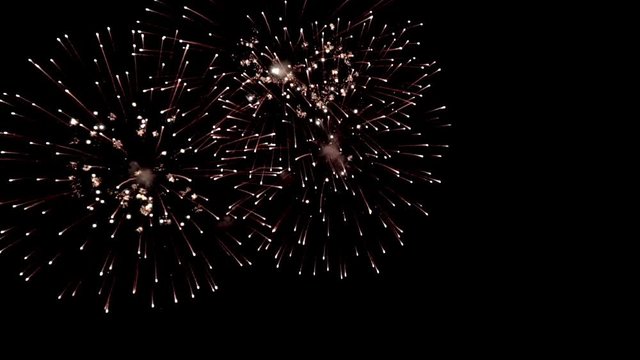 Bright colorful fireworks turn to multicolor bokeh lights at holiday dark summer night.