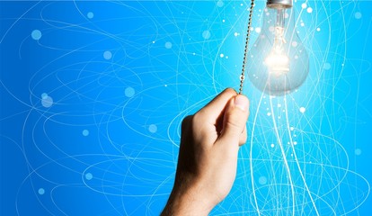 Hand turning off the bulb lamp.Turning off the light.