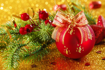 Red Christmas balls on a gold background with bokeh