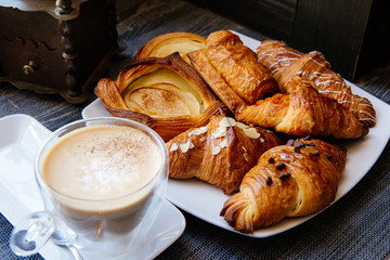 different types of croissants with coffee on table