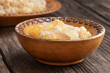 Frankincense resin crystals in a wooden bowl