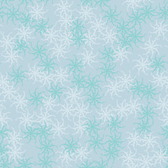 Winter seamless pattern with chaotic snowflakes in different shades of blue color