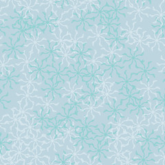 Winter seamless pattern with chaotic snowflakes in different shades of blue color