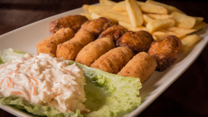 Croquettes with chips and surimi salad
