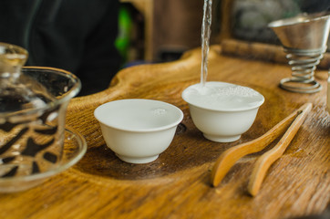 Chinese tea ceremony with Anchnag on wooden background