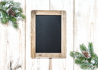 Chalkboard Christmas tree branches wooden background