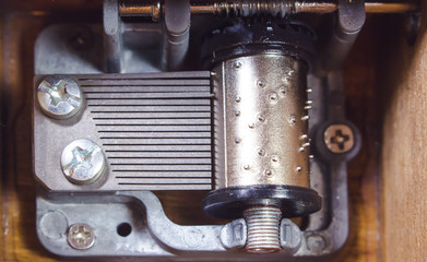 Top view of the insides of a music box. Macro of the music box mechanism and gears.