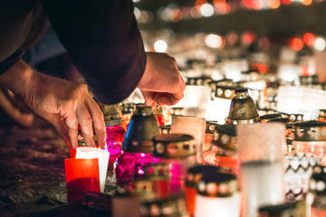 Latvian patriots lighting candles as a tribute to fallen freedom fighters. Hundreds of lighten up candles creating cosy atmosphere. Lāčplēša diena - day of independence of Latvia.  © Viesturs
