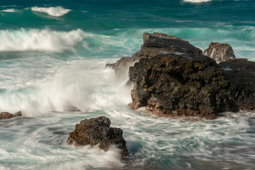 Naklejka premium Tropical sea with waves on cliffs - Motion Blur, Soft Focus due to Slow Shutter Speed