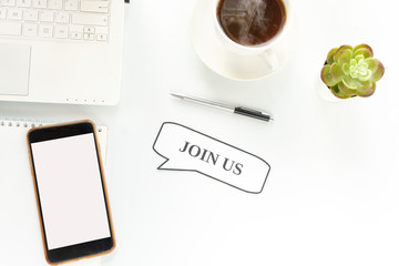 Notepad on workplace table and written JOIN US concept