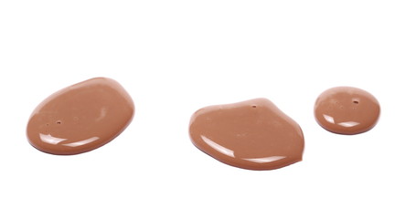 Spilled chocolate milk puddle isolated on white background